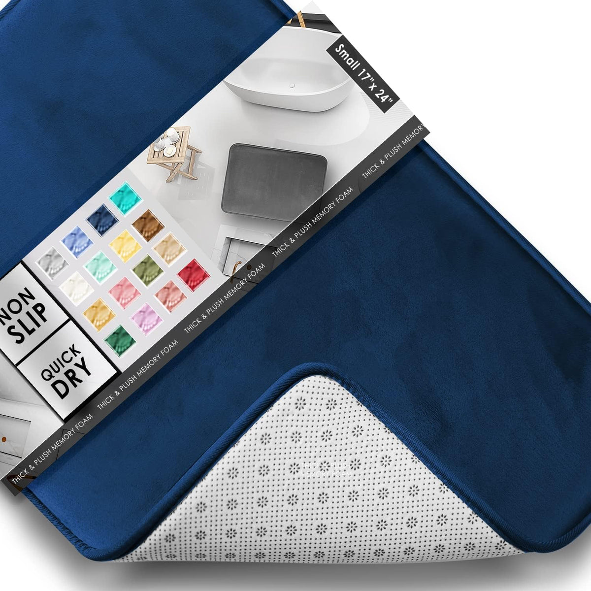 Diagonal close-up of a deep navy rectangular bath mat with corner flipped to show dotted white non-slip backing and