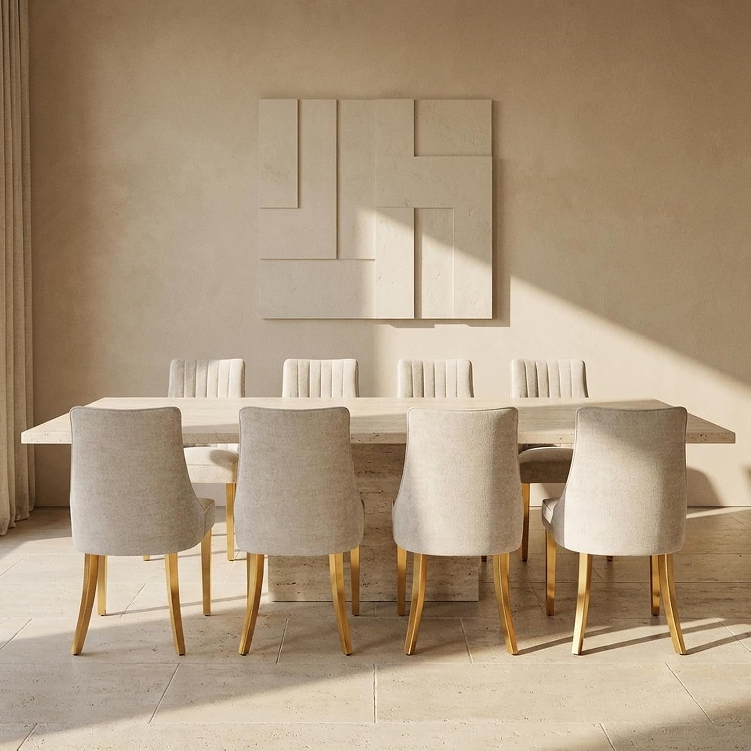 Eight light beige upholstered chairs with gold-finished legs arranged around a pale stone dining table.