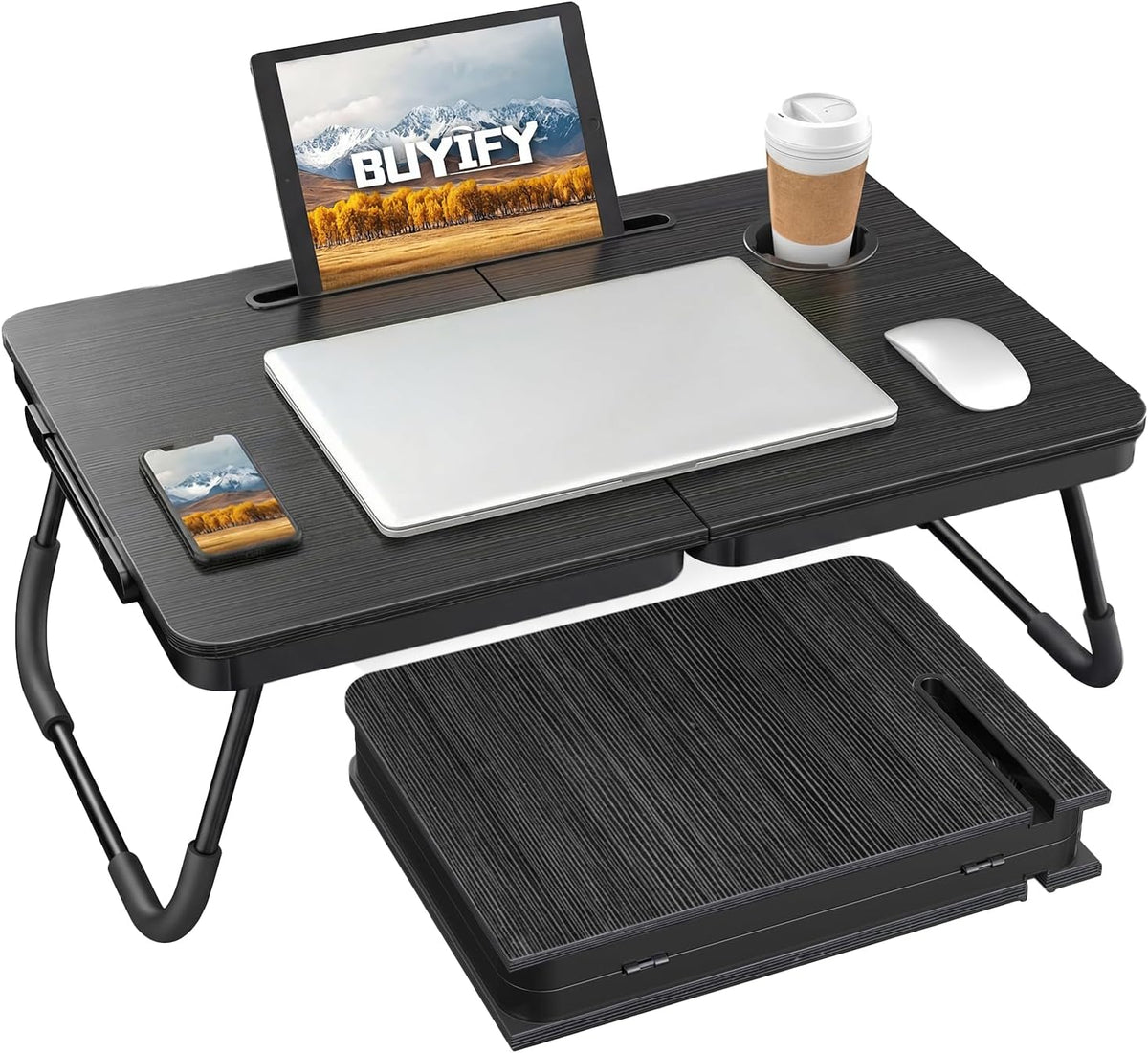 Black foldable lap desk on a bed with laptop on surface, tablet in stand groove and cup in holder