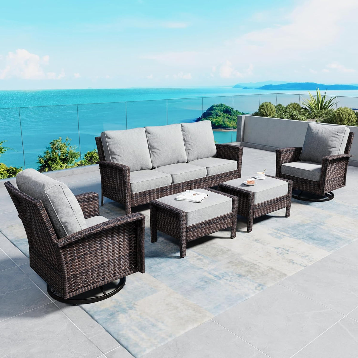 Three-seat sofa with two swivel chairs and two ottomans beside a low coffee table on a tiled patio.