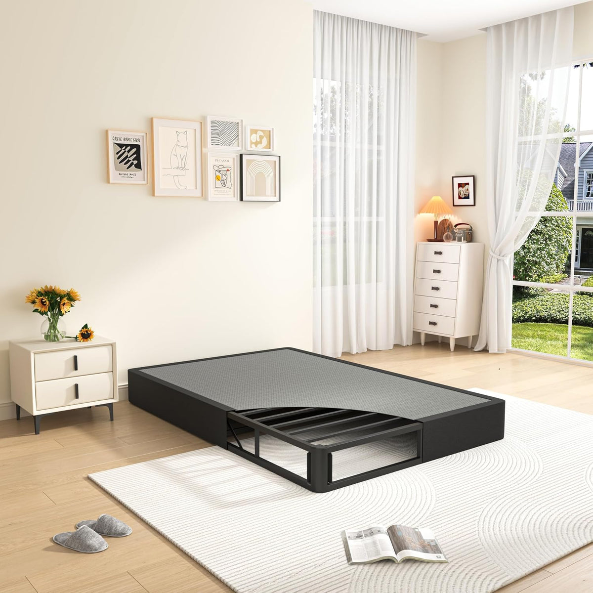 Low profile black fabric-covered foundation with an exposed metal support frame pulled out from one corner.