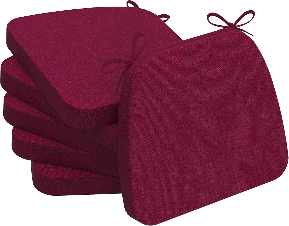 Four burgundy D-shaped seat cushions stacked and fanned, one tilted forward to show thickness