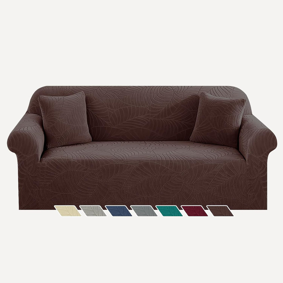 Front view of a three-seat sofa dressed in a rich chocolate brown leaf-pattern slipcover with two matching pillows and
