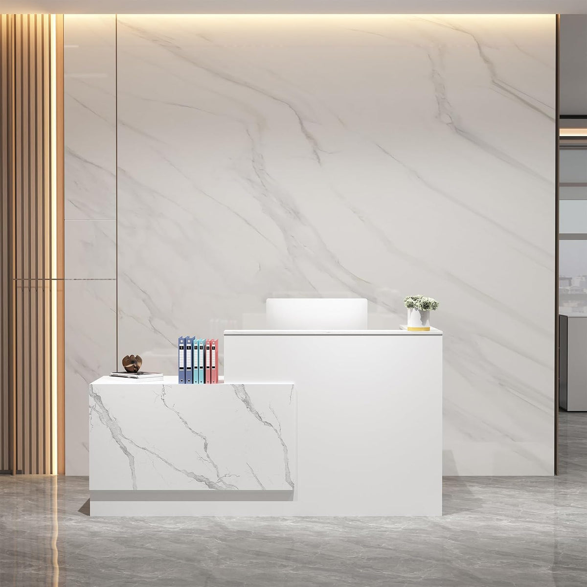 White reception desk with marble-patterned return against a large veined marble wall and files on top