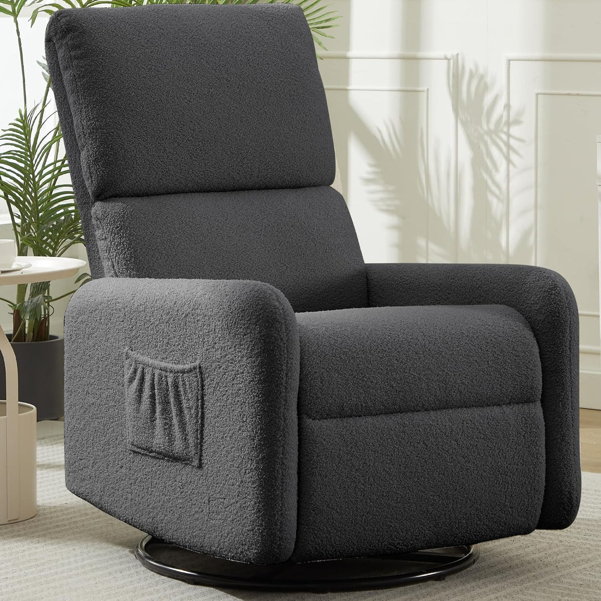 Dark charcoal sherpa swivel rocker with a side pocket on the arm, placed on a light rug.