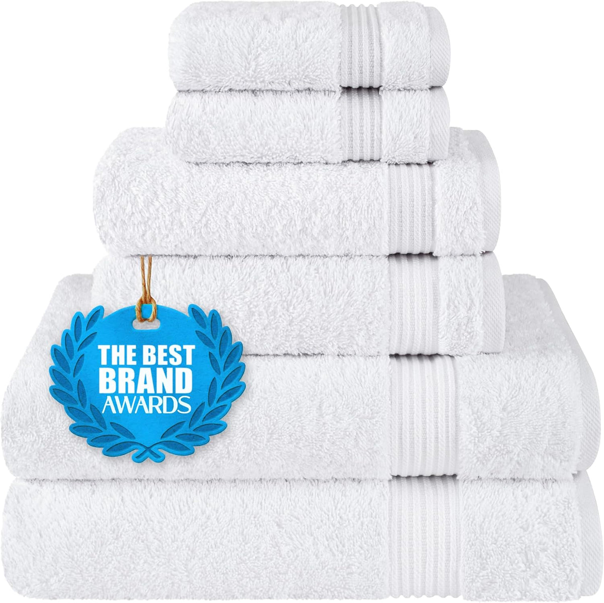 Stacked white towels in a neat pile with a blue award tag hanging on the front