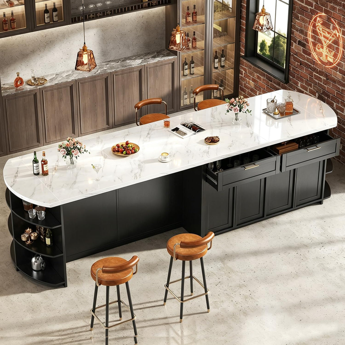 High-angle view of a long black kitchen island with white faux‑marble top, two open drawers showing glassware, curved end