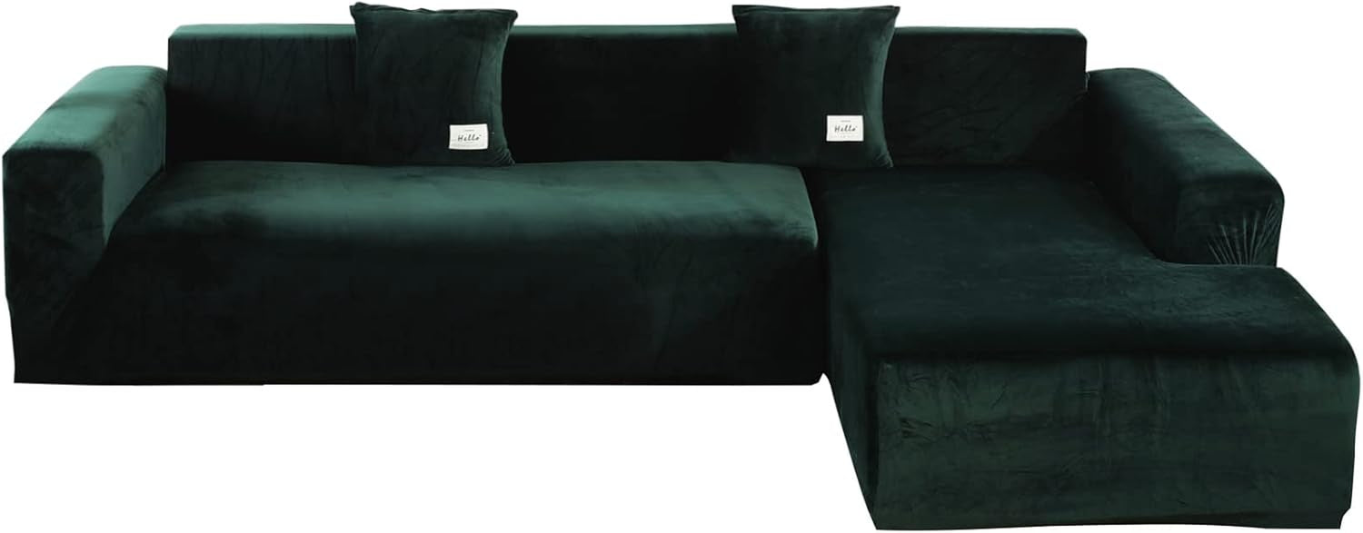 Dark green velvet L-shaped sectional slipcover front view on separated sofa pieces with two square pillows
