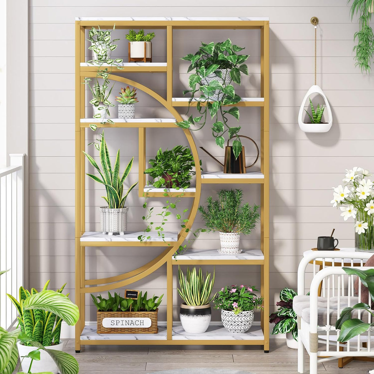 Gold half-moon etagere styled with multiple potted plants on a porch-like setting, front view