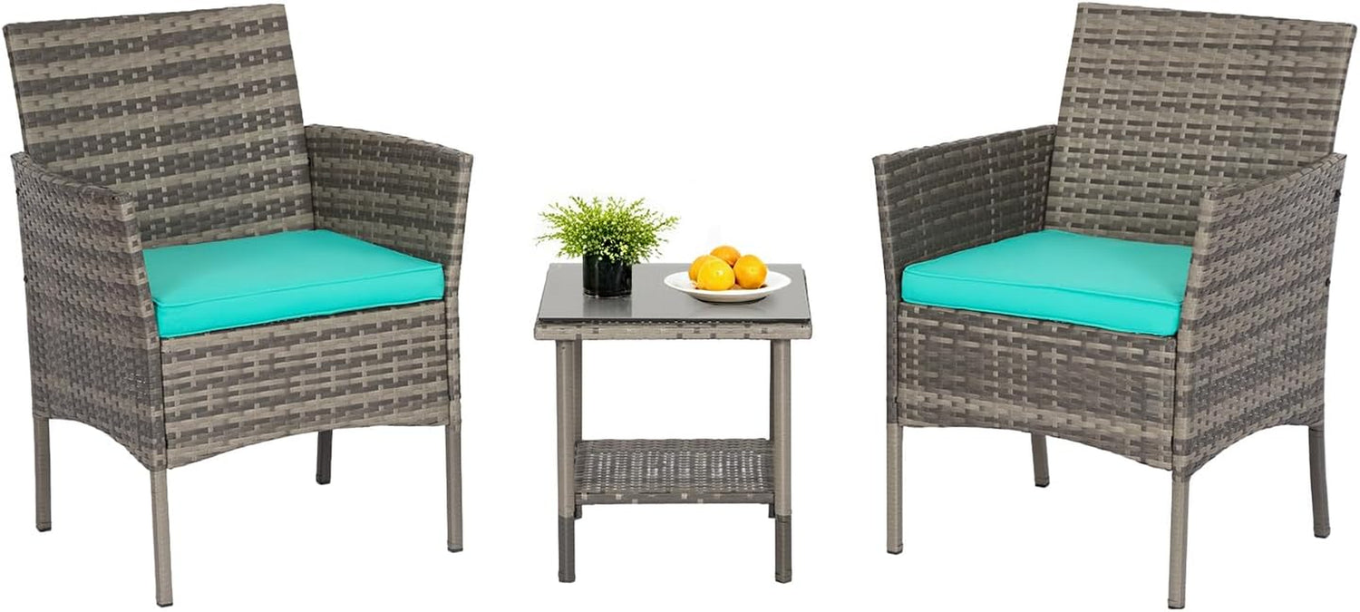 Two gray wicker armchairs flanking a glass-top side table with turquoise cushions