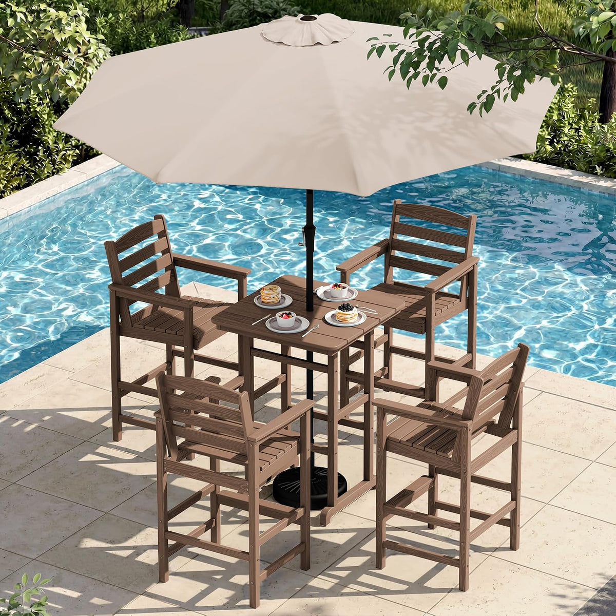Brown bar table and four matching bar-height Adirondack chairs next to a pool with a beige umbrella overhead.