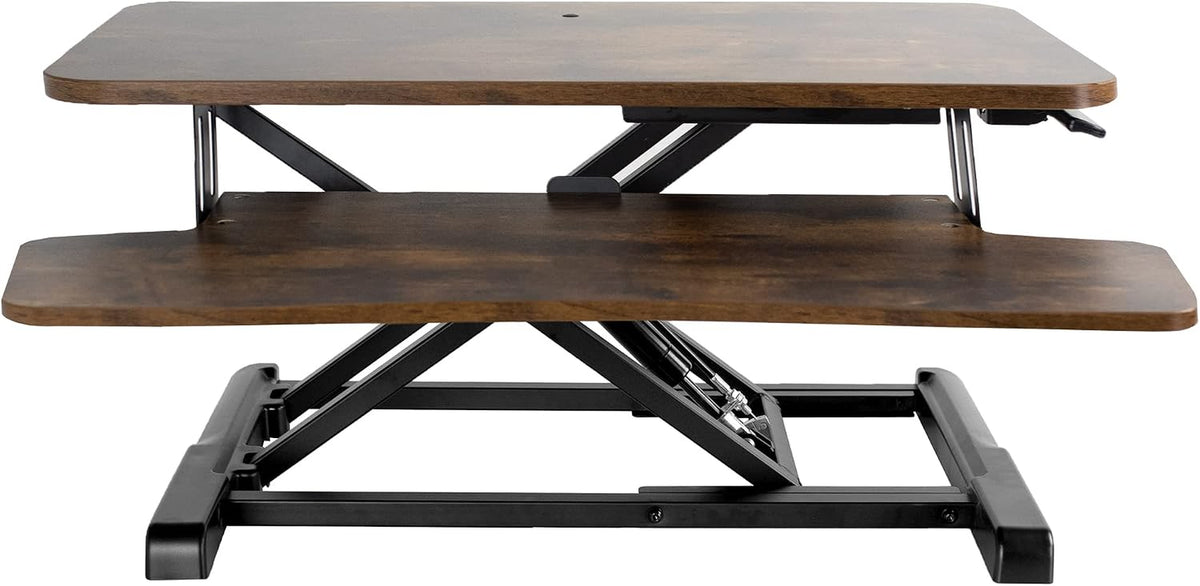 Front view of a dark brown two-tier standing desk converter with black metal X-frame base.