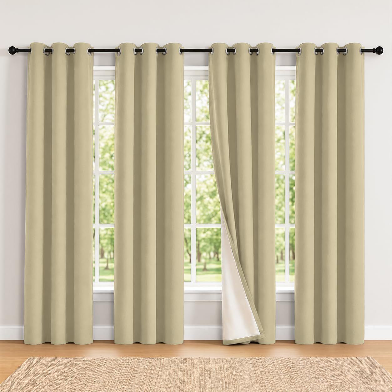 Wide front view of light beige grommet curtains covering a large window, one panel pulled to show white lining