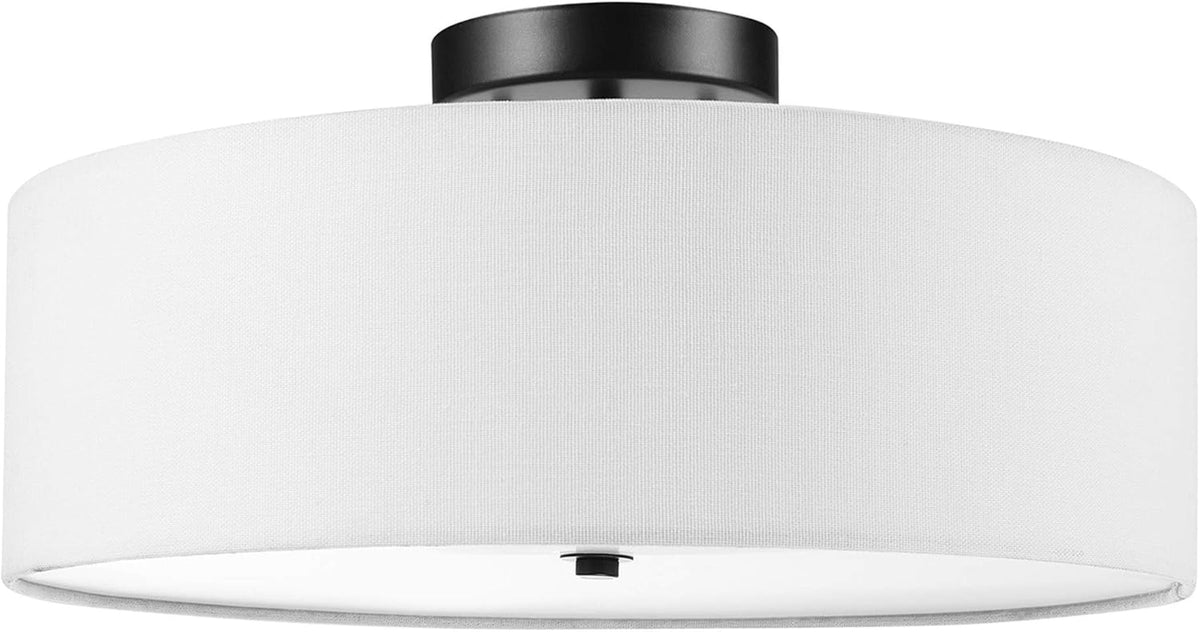 Front-facing close-up of a white fabric drum shade flush to the ceiling with a dark round canopy above.