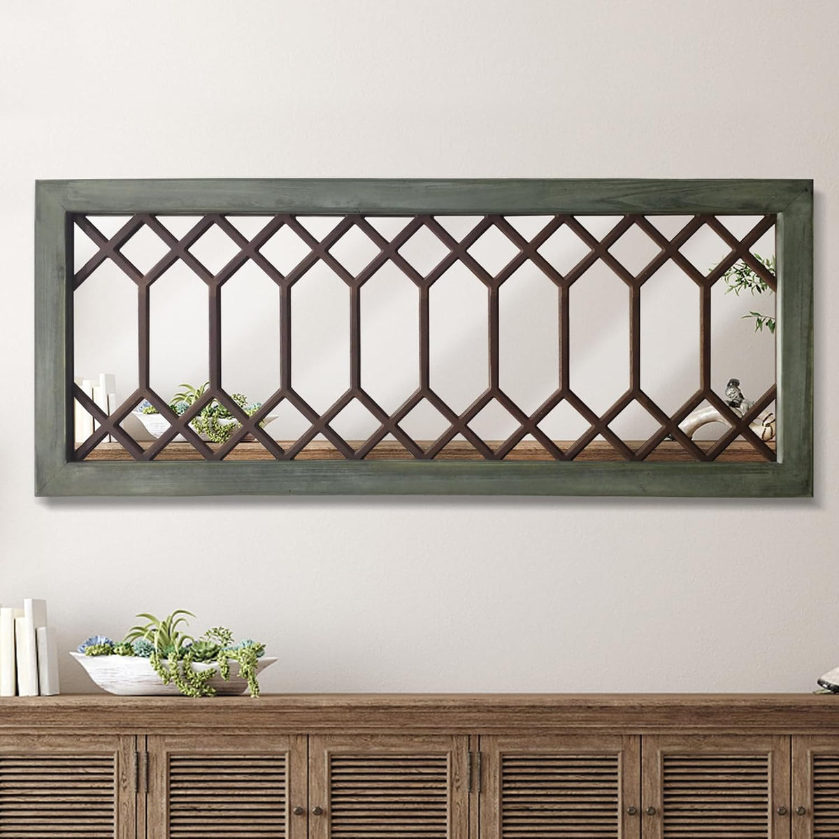 Long rectangular mirror with a green-painted frame and brown lattice grille mounted over a wood sideboard.