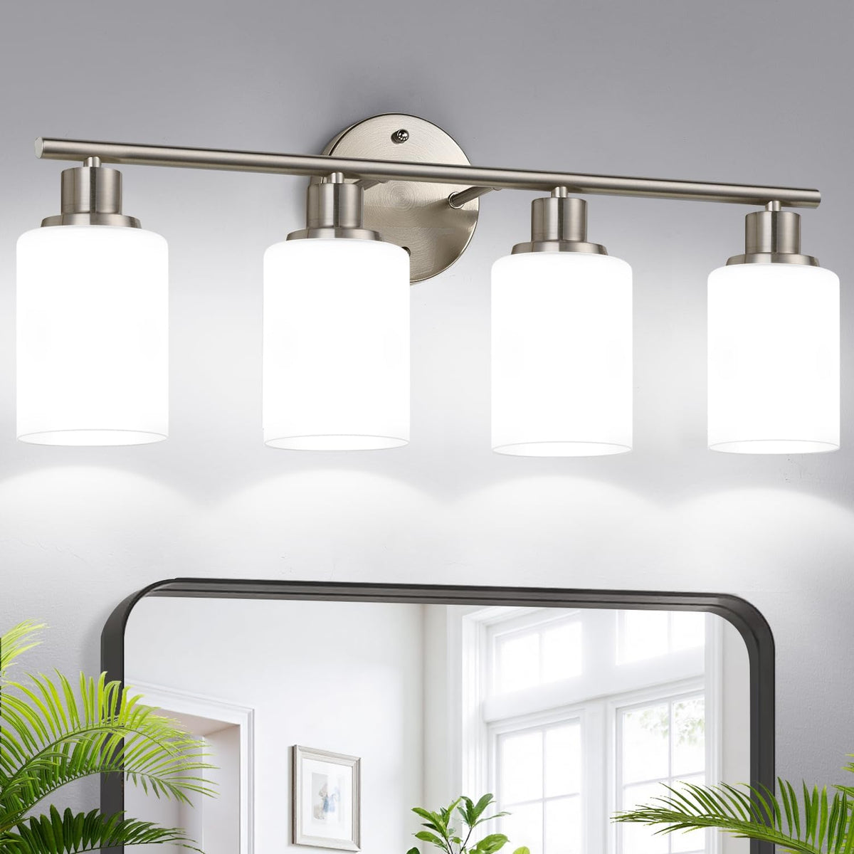 Wide view of a four-light vanity with frosted white cylindrical shades and brushed nickel finish over a mirror.