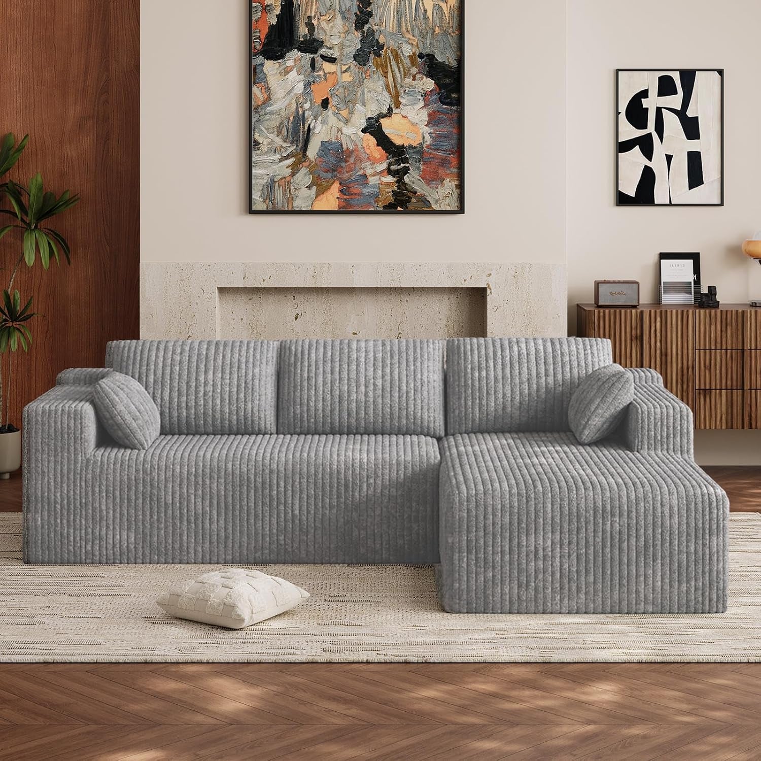 Front view of a light gray L-shaped sectional with right-side chaise in a living room.