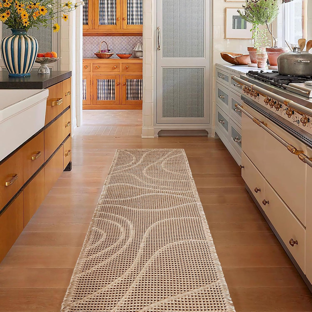 Kitchen view showing a beige waffle runner mat centered on hardwood between lower cabinets and a stove