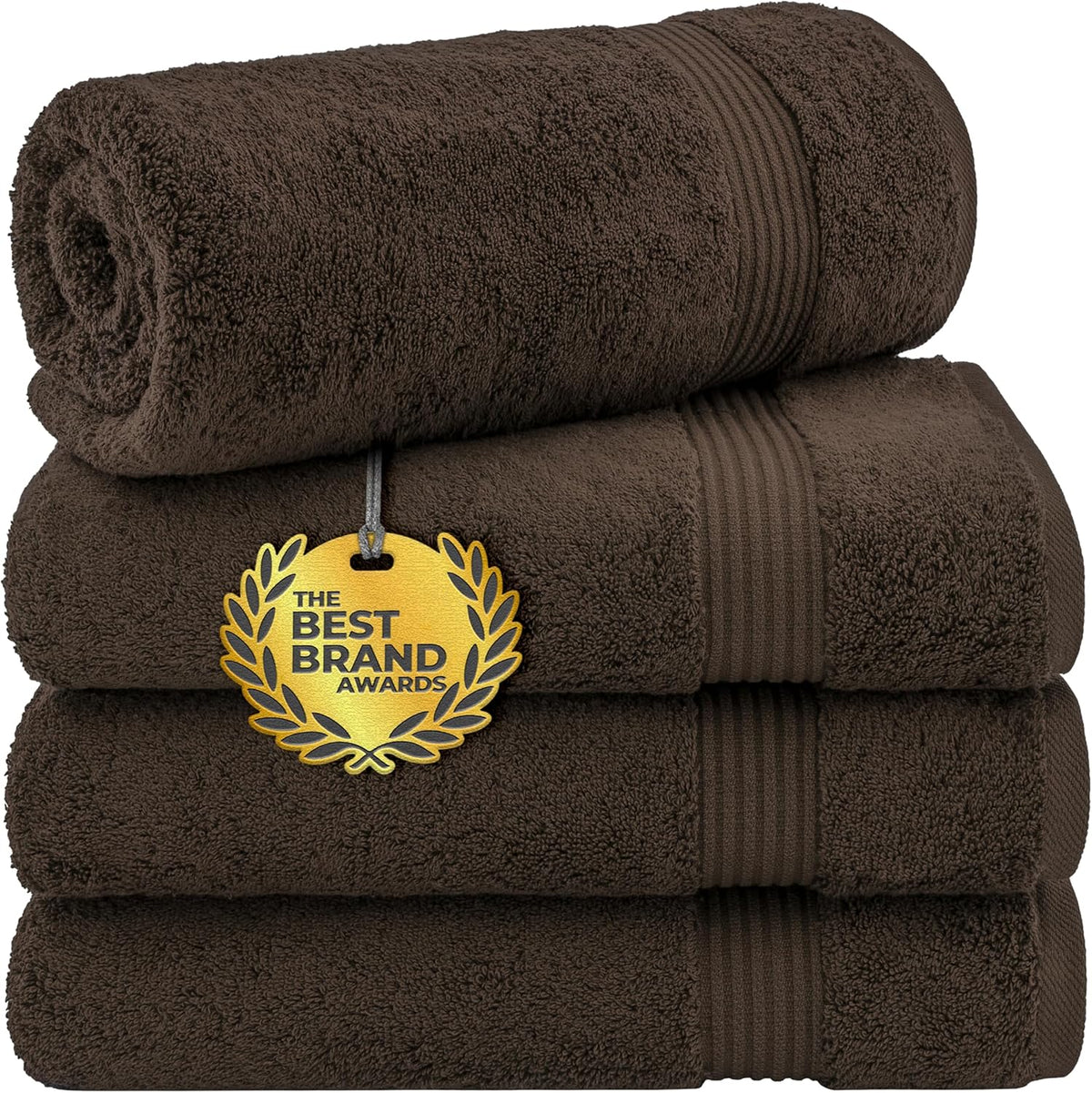 Stack of dark brown towels with one rolled on top and a gold award medallion attached