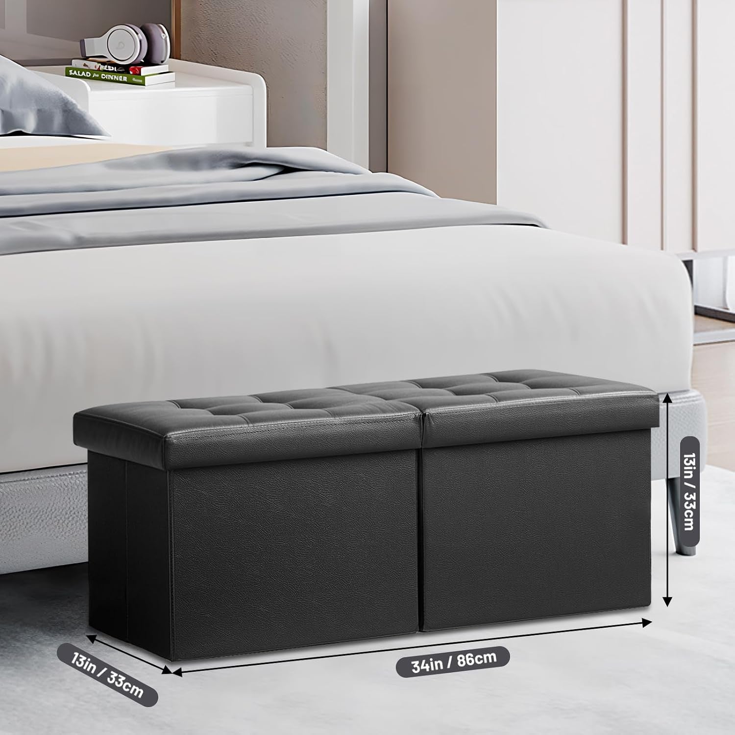 Black leather ottoman beside a bed with dimensions callouts showing 34in length and 13in height