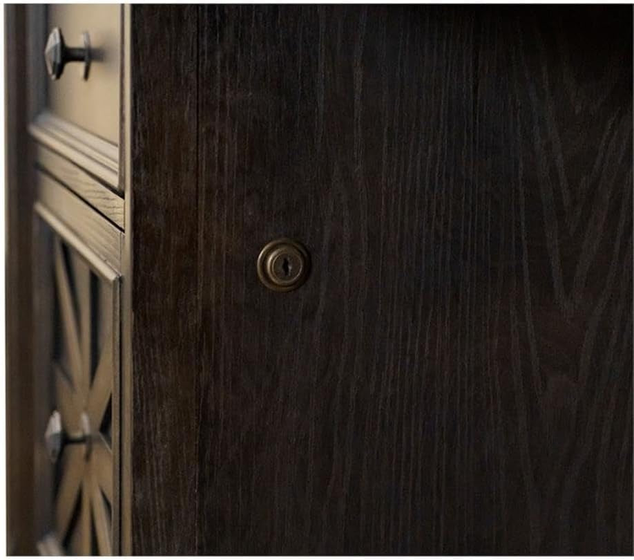 Close-up of a side panel showing dark wood grain and a small round metal keyhole lock.