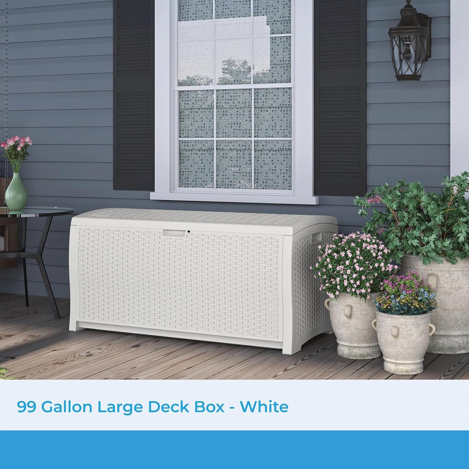 White wicker-style deck box on a porch under a window with potted plants at right