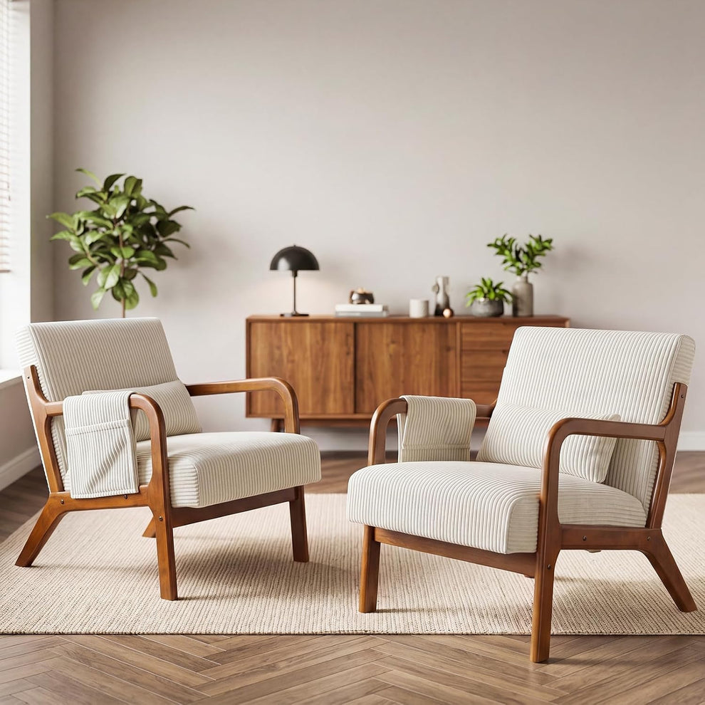 Pair of beige upholstered accent chairs with wooden frames placed on a rug in a living room setting