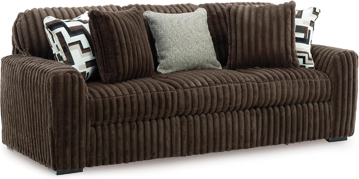 Chocolate-brown corduroy sofa (no chaise) with rolled arms and five decorative pillows