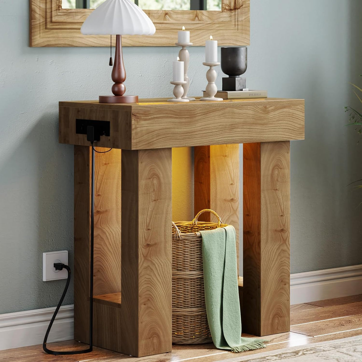 Tight crop showing vertical wood grain on the console leg and the power cord routed down to the outlet.