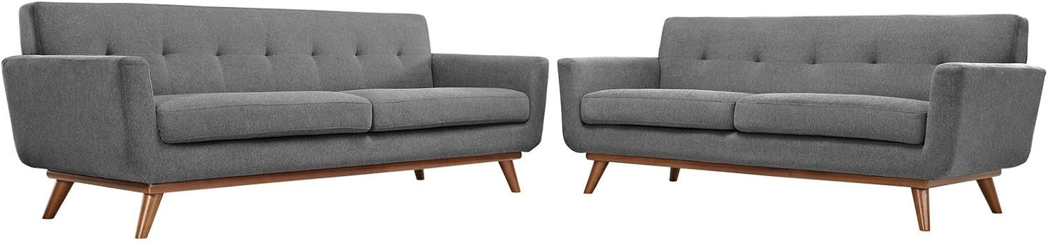 Clean studio image of a matching pair of gray sofas side-by-side on a white background showing wood bases