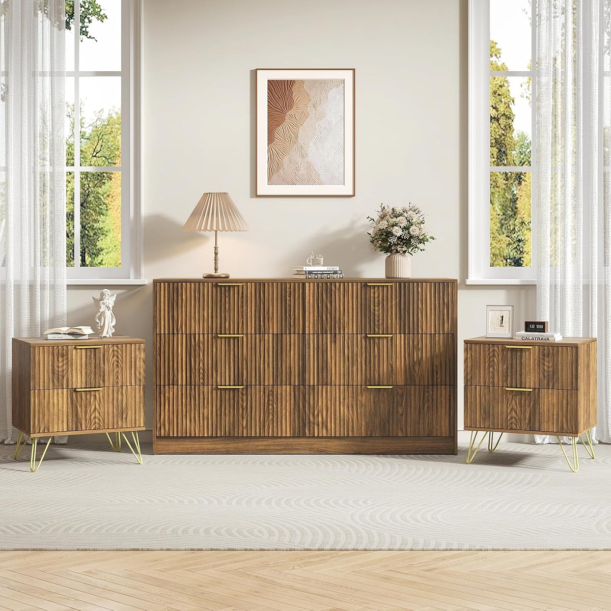 Walnut fluted dresser and two matching nightstands beneath abstract framed art, with lamp, flowers and sheer windows.
