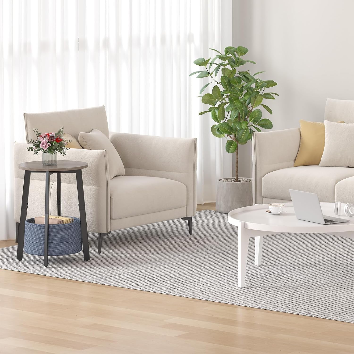 Round side table with dark metal legs and blue cloth basket next to a beige armchair in a living room.