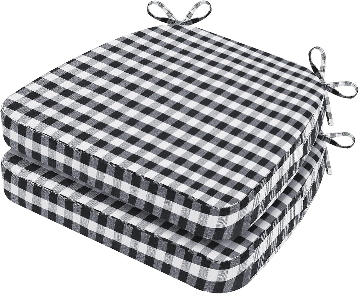Two black-and-white gingham D-shaped chair cushions stacked, top view angled to show check pattern and tied bows.