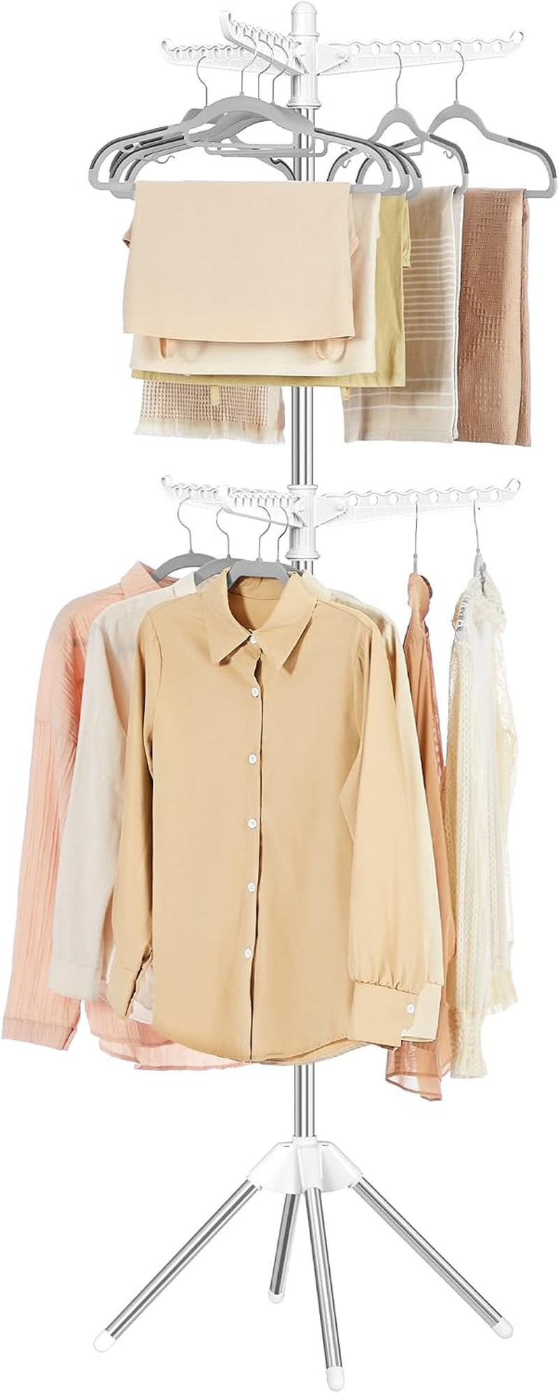 White two-tier drying rack topped with hangers, folded towels and blouses on the upper arms and shirts below.