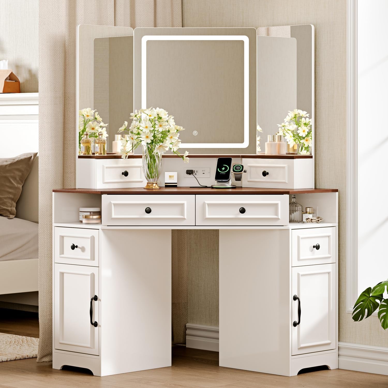 White vanity with walnut-toned top, three-panel mirror with lit square center, drawers and cabinets