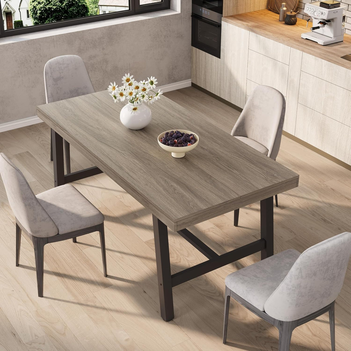 Rectangular dining table with light gray wood top and black metal legs shown with four upholstered chairs.