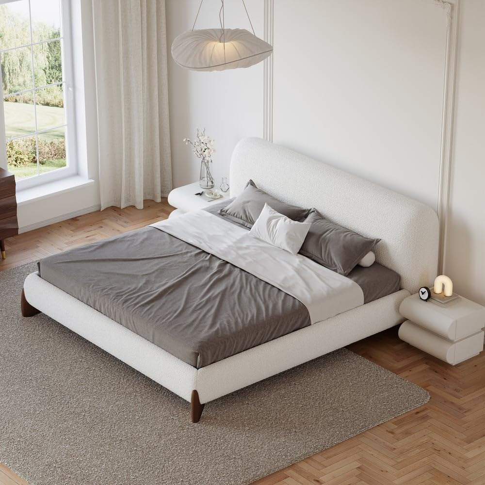 Angled overhead view of white boucle platform bed with matching nightstands and gray bedding in a bright room