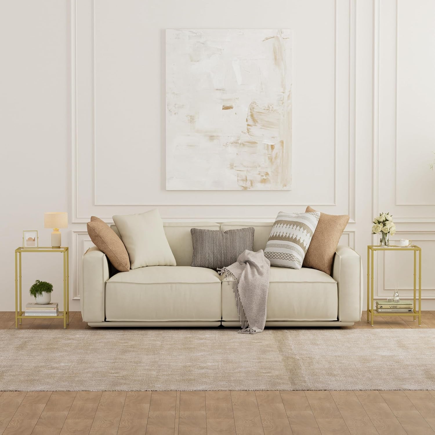 Gold side tables flanking a cream sofa in a living room setting