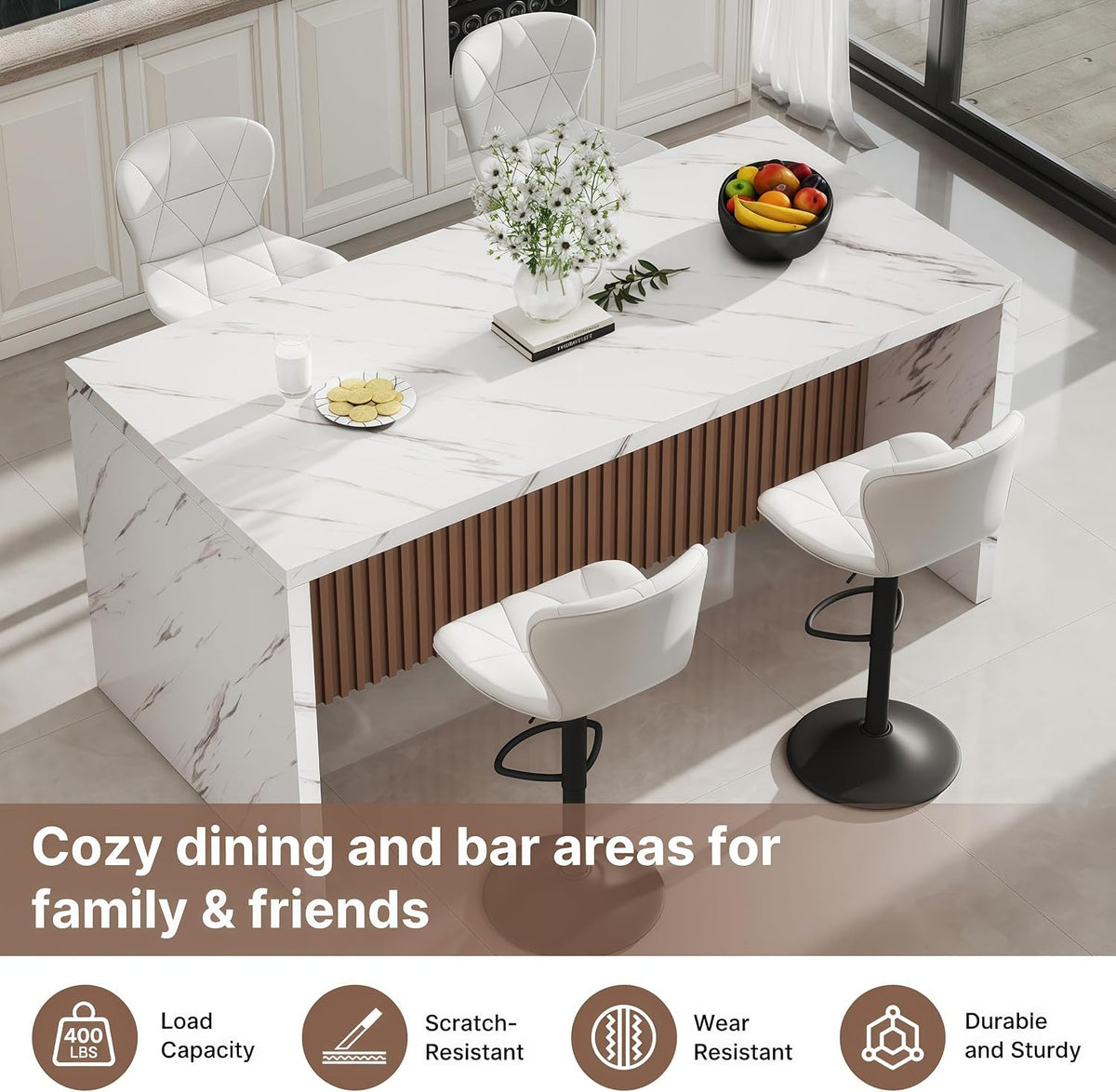 Overhead angled view of white faux-marble island table with brown fluted front and white stools.