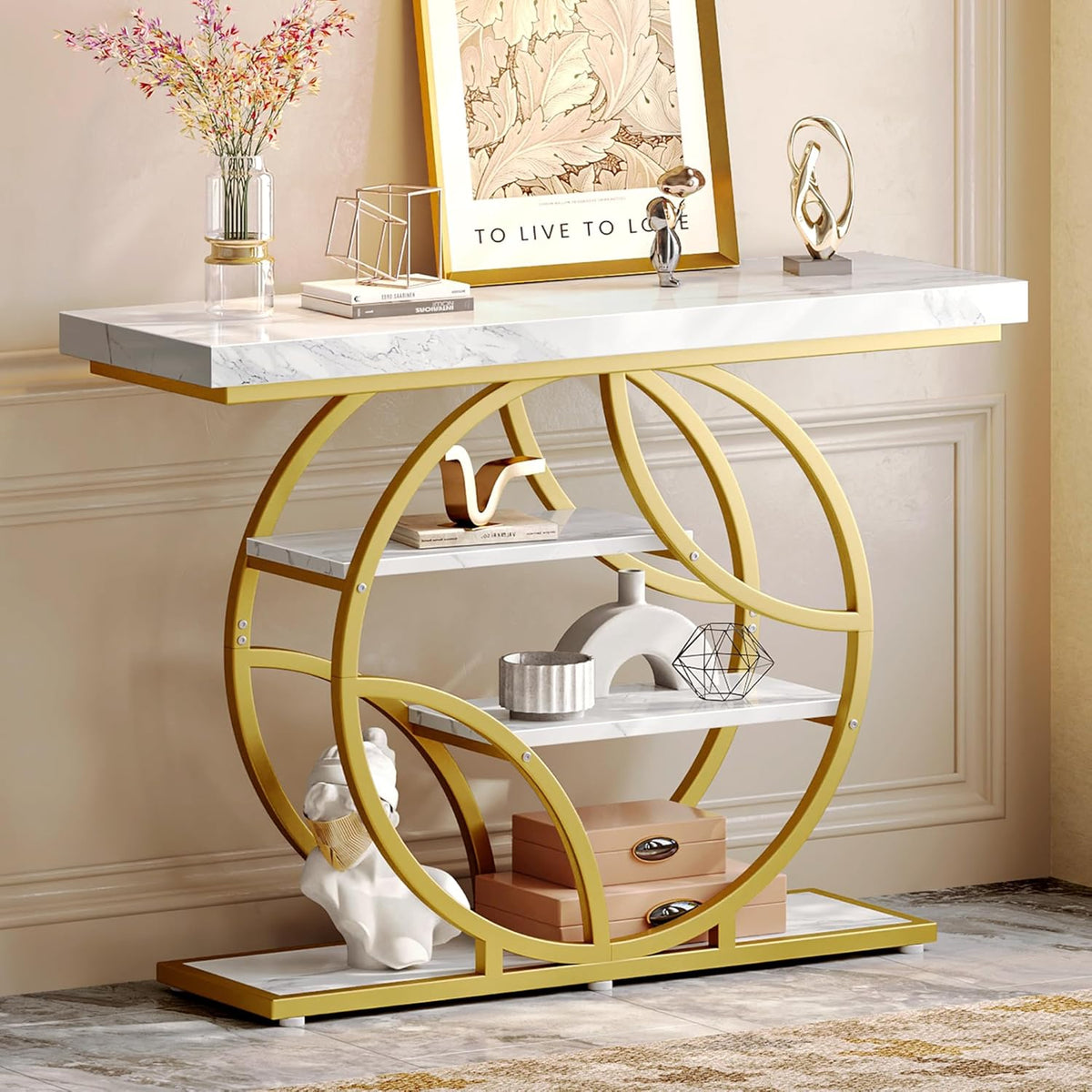 Angled view of the gold-framed console showing its circular silhouette, three shelves, and tabletop styling.