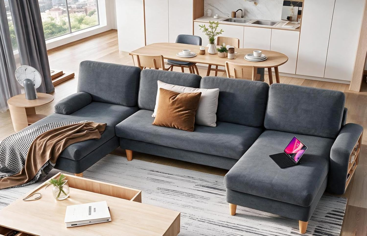 Dark gray sectional sofa with chaise in a bright modern living room with dining area behind