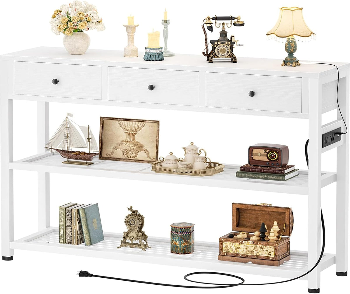 White console table shown front-on with decorative objects and two slatted shelves, black power cord visible