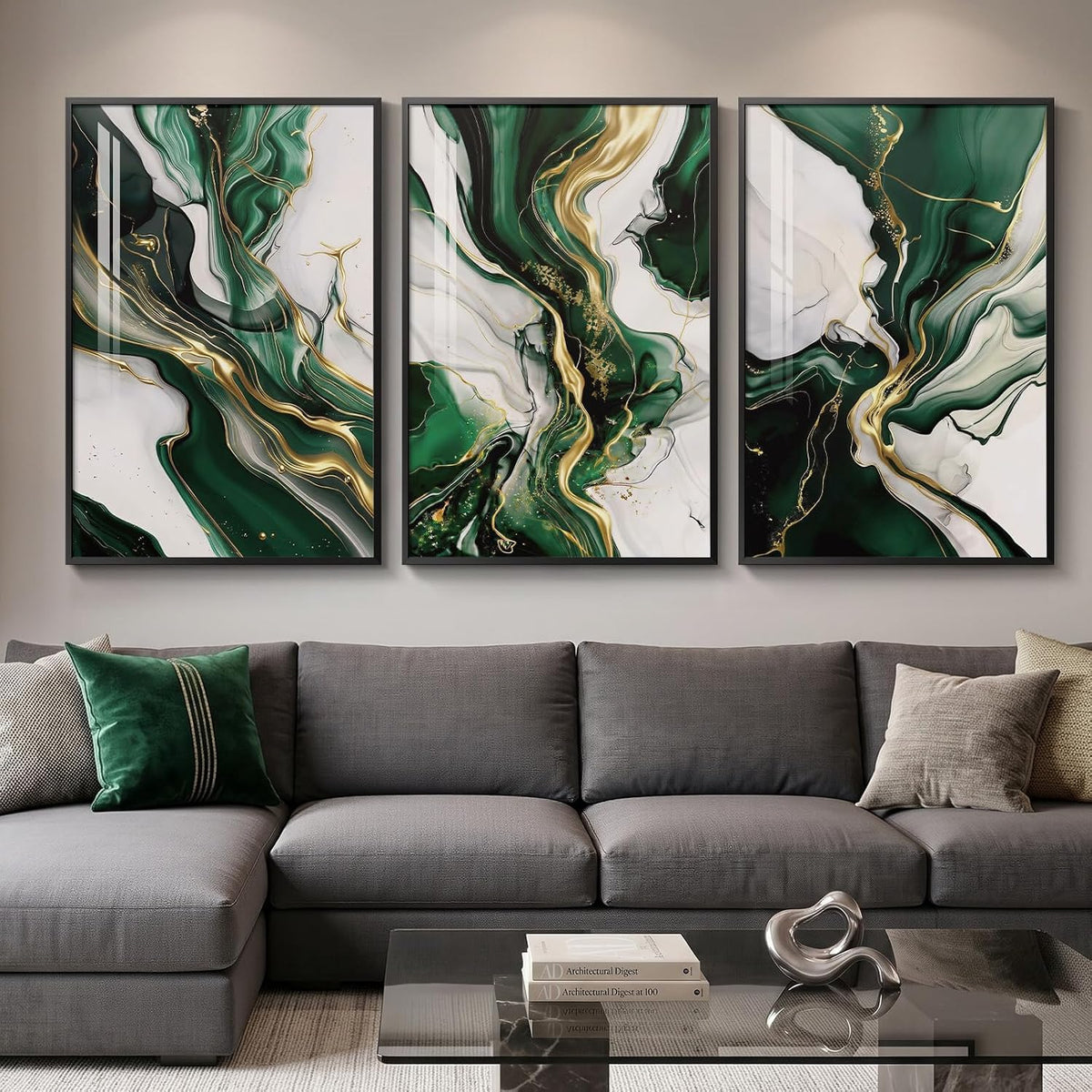 Three green-and-gold marbled panels hung above a gray sectional, with glossy reflections on the frames.