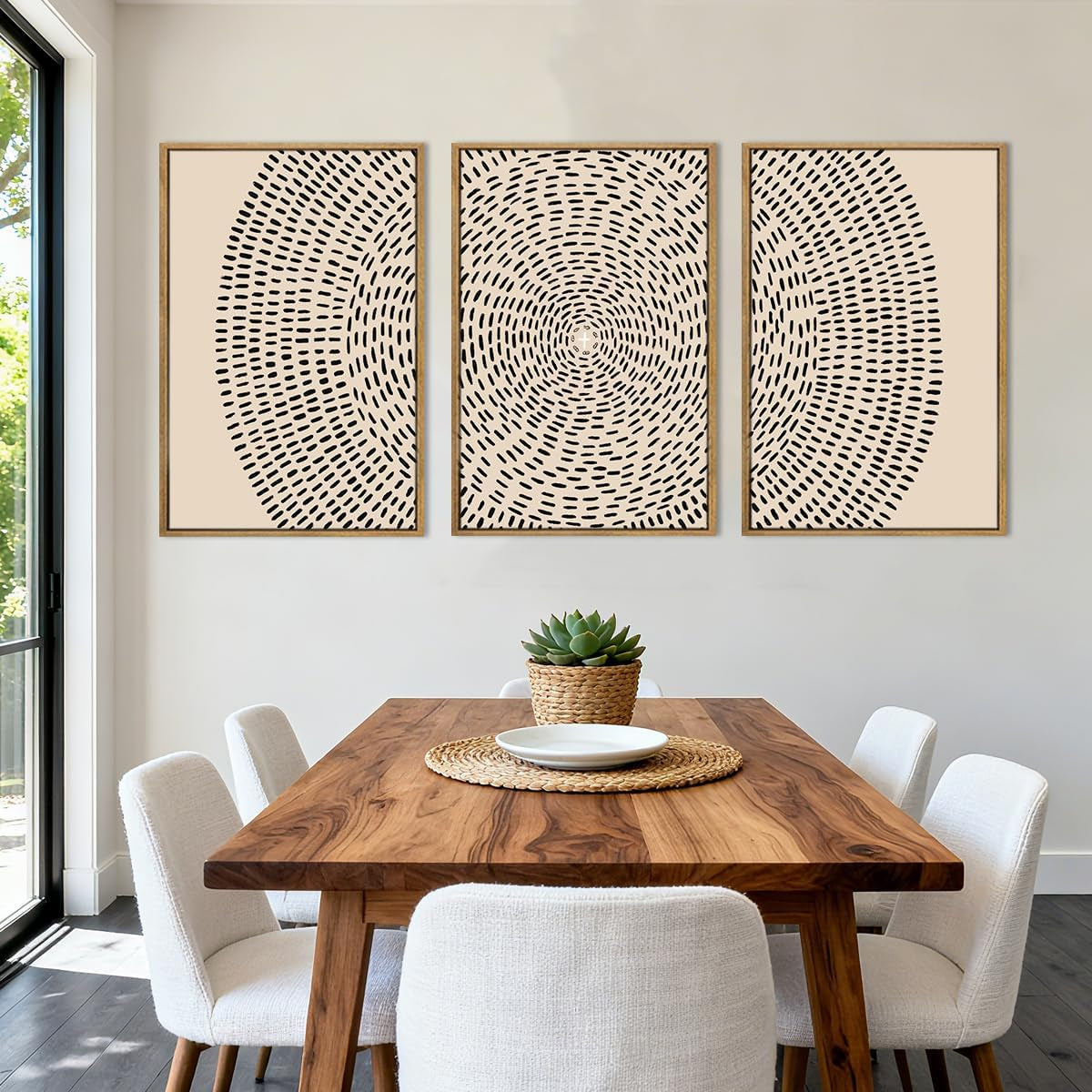 Three framed beige canvas artworks with concentric dashed pattern displayed above a dining table