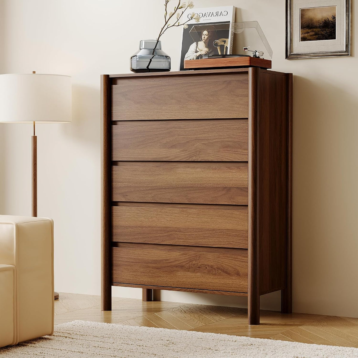 Tall walnut chest shown from the side with round legs and a floor lamp beside it.