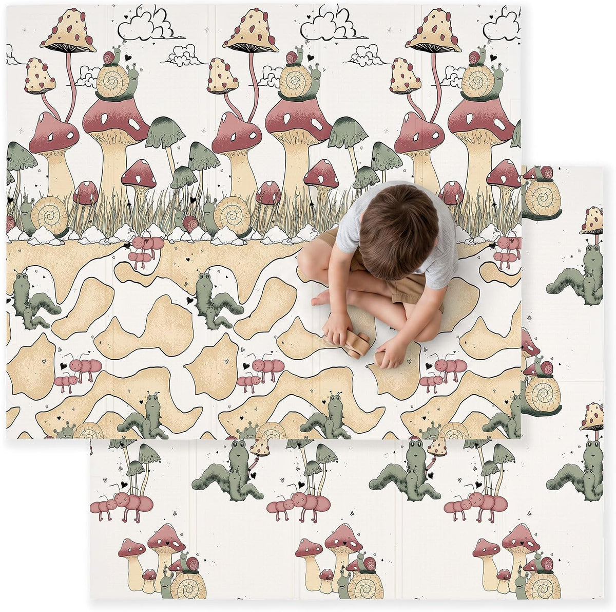 Top-down view of a child sitting cross-legged on a mushroom-and-snail patterned foldable play mat.