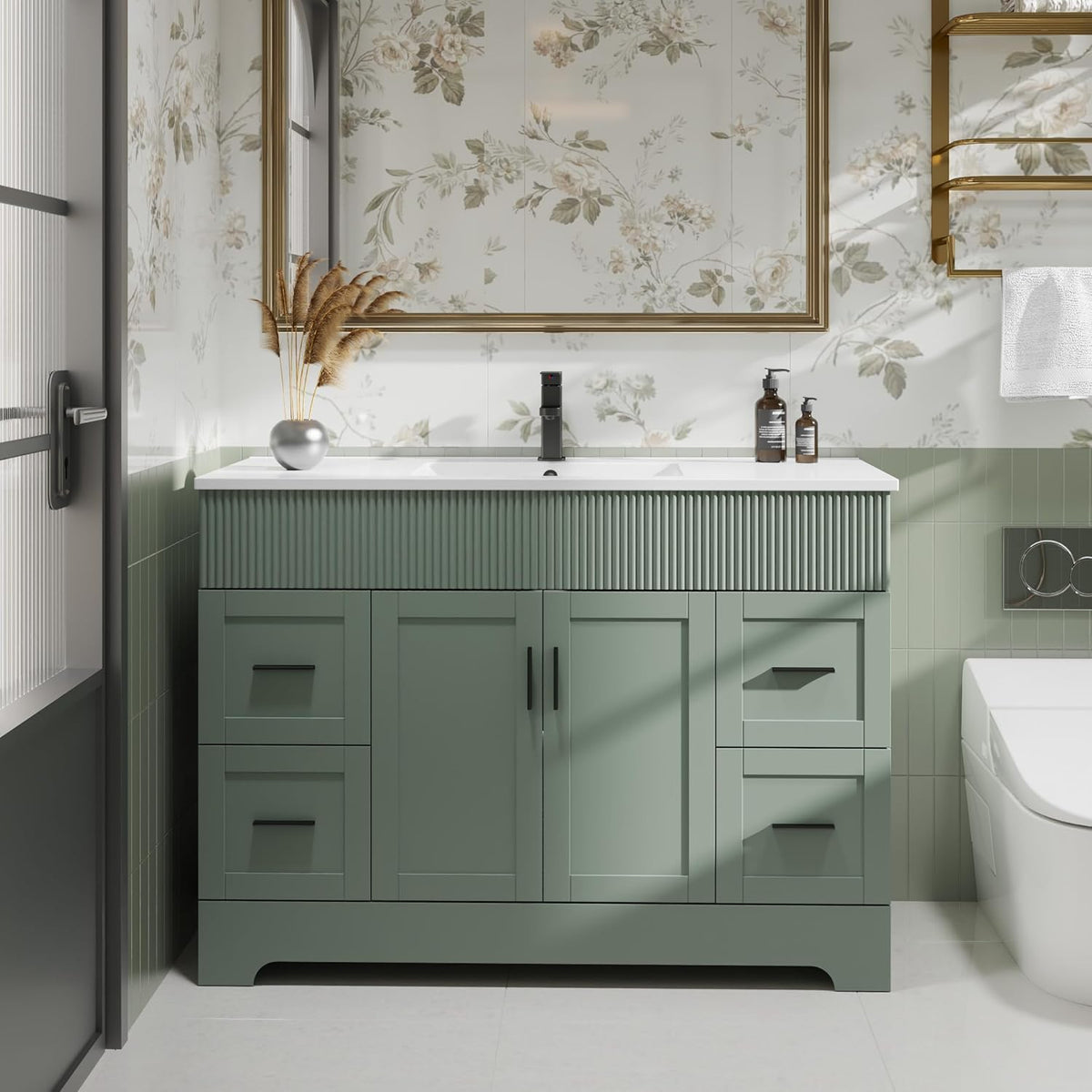 Centered view of the vanity top with white sink, black faucet and decorative ribbed front panel.