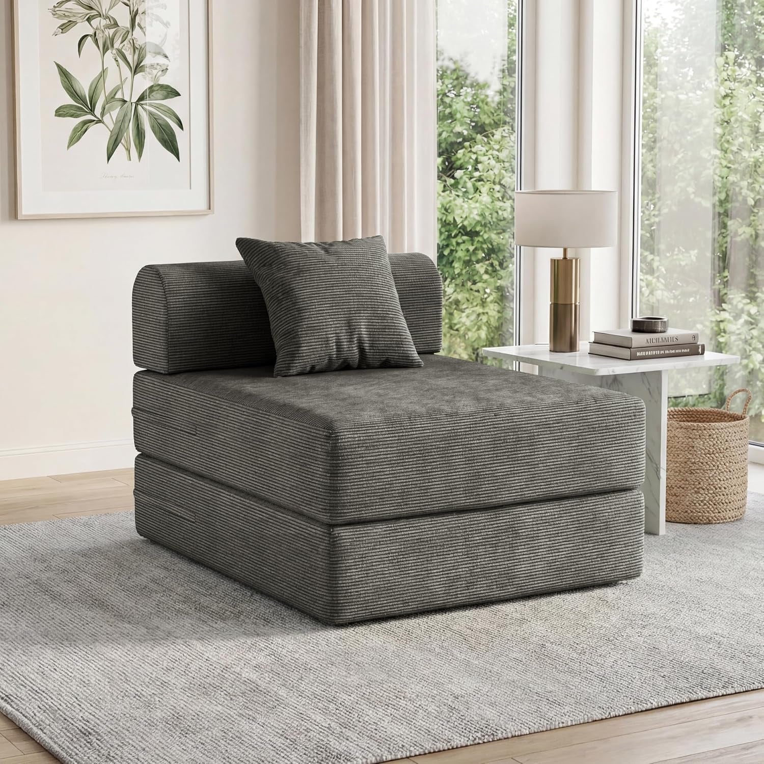 Single-seat gray corduroy folding sofa with lumbar pillow in a sunlit living room.