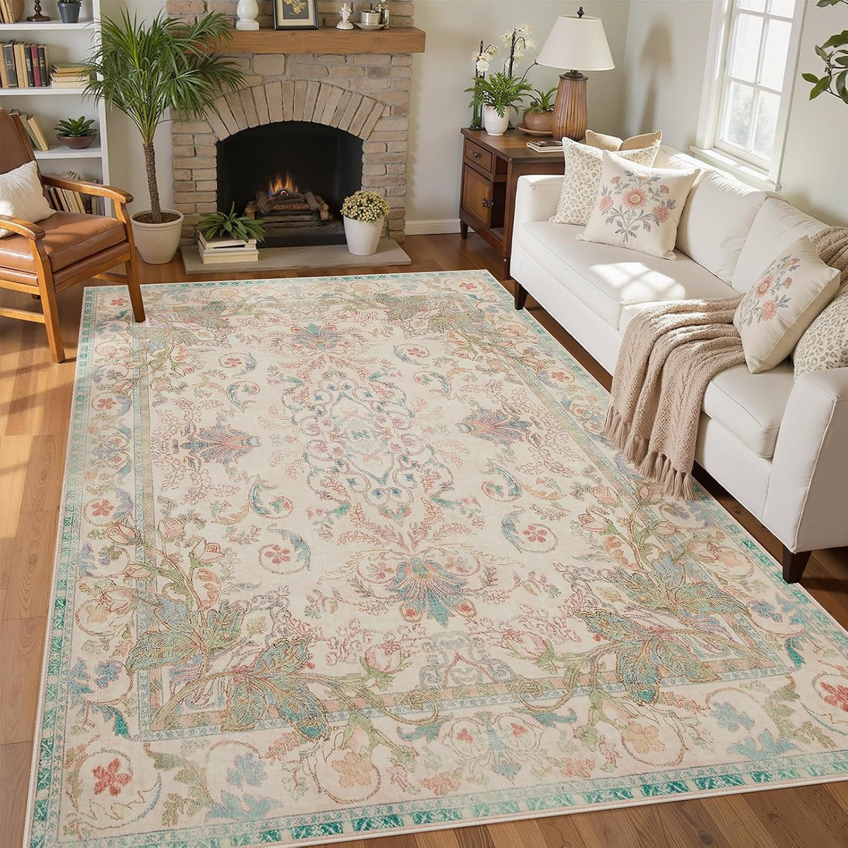 Bright living room showing a cream-and-mint floral rug beside a white sofa with textured throw.