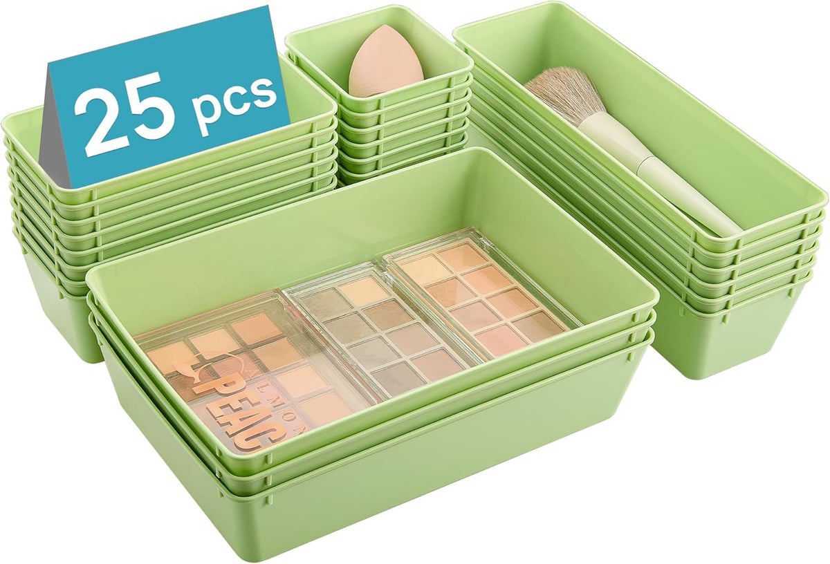 Three stacks of pale green organizers shown from an angle with a brush and sponge in the bins